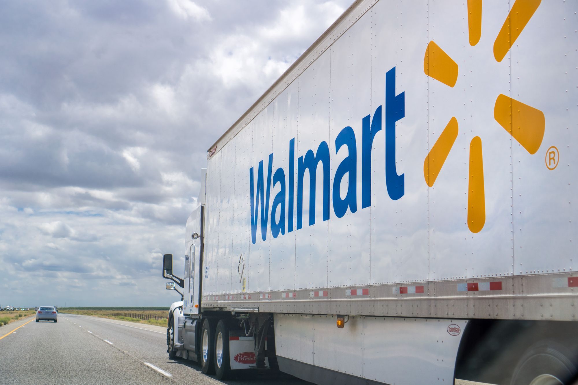 A Walmart truck hauling goods on the highway.