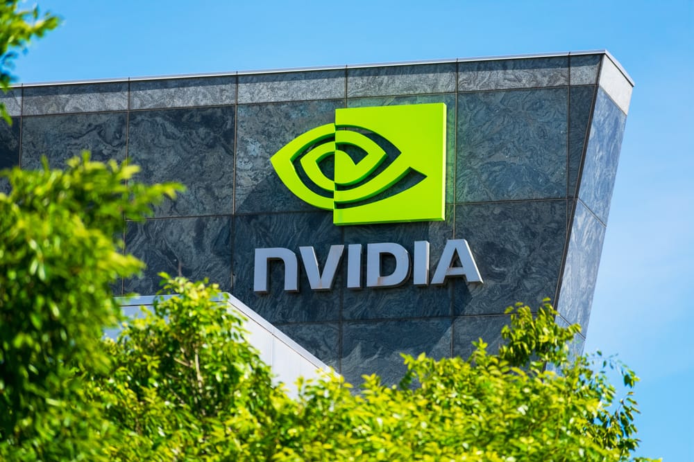 Nvidia logo and sign on headquarters. Blurred foreground with green trees - Santa Clara, California, USA - 2020.