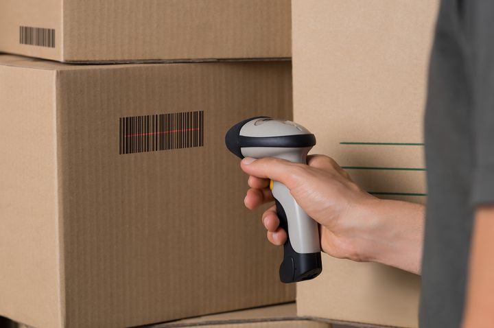 Portable Barcode scanner used on a box's barcode