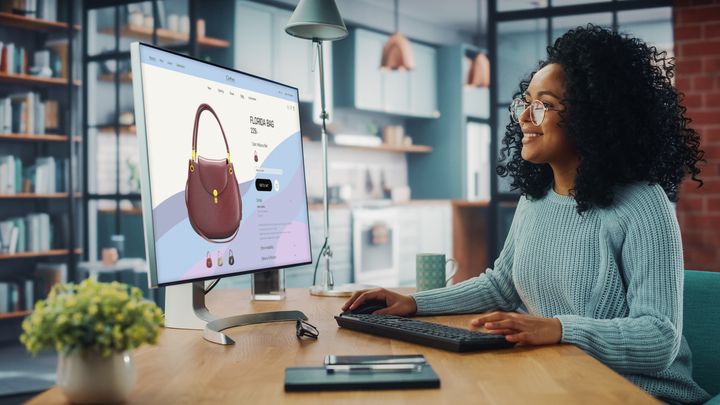 Young woman enjoying online shopping on a desktop