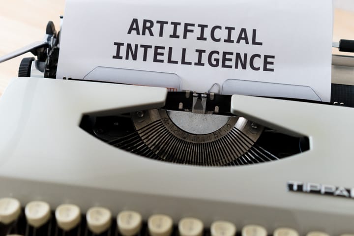 A typewriter with "ARTIFICIAL INTELLIGENCE" written paper.